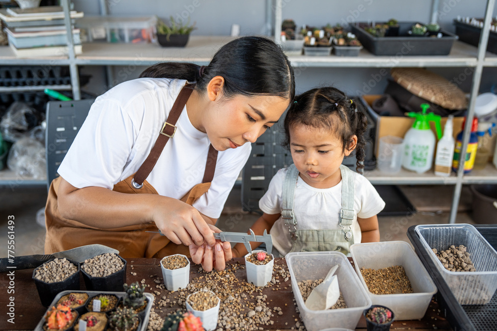 Happy family mother and her daughter concept, asian young mom and baby girl spending time together with planting, parent and her child doing hobby, the quality time for children activities at home. Happy family mother and her daughter concept, asian young mom and baby girl spending time together with planting, parent and her child doing hobby, the quality time for children activities at home.
