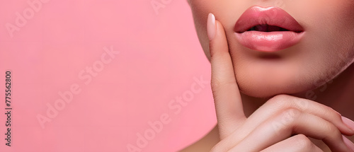 Close-up of attractive woman's face with pink lipstick on lips.