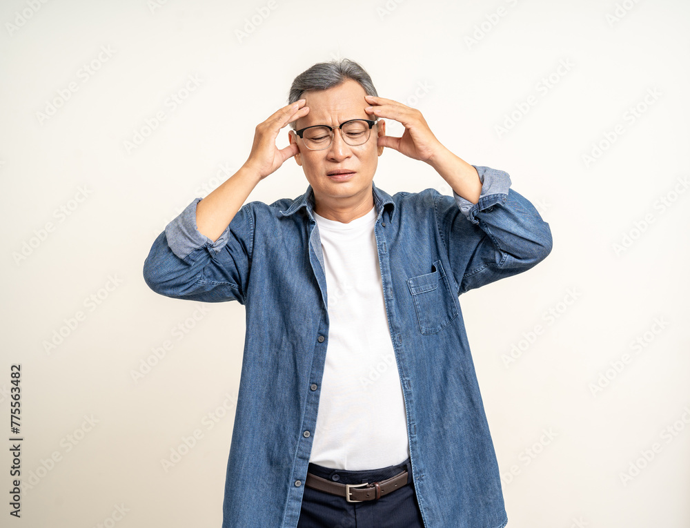 Handsome asian mature old man standing headache on isolated white background. Portrait of serious depressed senior asian man looking at camera. Mature People and lifestyle Handsome asian mature old man standing headache on isolated white background. Portrait of serious depressed senior asian man looking at camera. Mature People and lifestyle