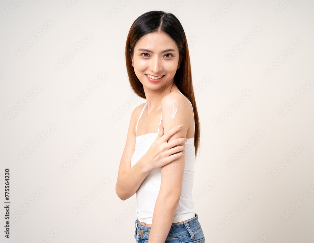 Beautiful smiling happy young asian woman with beauty skin care treatment lotion on the body. Charming female lady standing pose applying body cream Facial treatment beauty and spa Beautiful smiling happy young asian woman with beauty skin care treatment lotion on the body. Charming female lady standing pose applying body cream Facial treatment beauty and spa