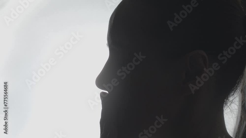Silhouette close-up, hand gestures, head and facial movements. Slow-mo photo