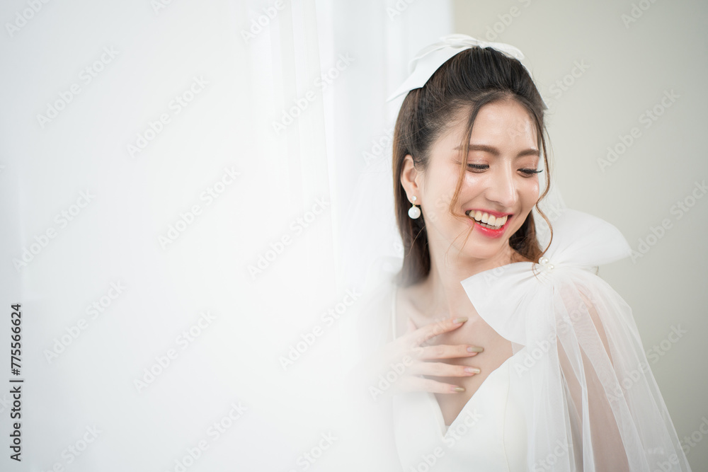Beautiful asian bride with fashion wedding hairstyle and makeup. Portrait of young gorgeous bride wedding studio shot in white room. Beautiful asian bride with fashion wedding hairstyle and makeup. Portrait of young gorgeous bride wedding studio shot in white room.
