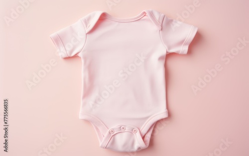 Pink baby onesie on pastel background