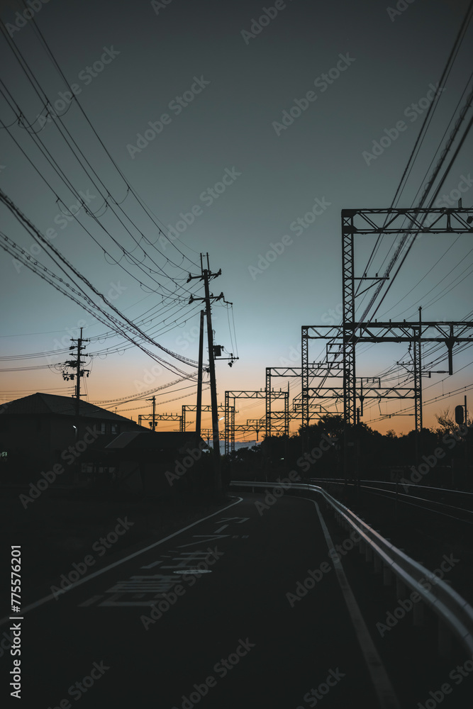power lines and train at sunset
