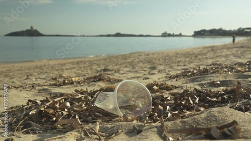 A plastic cup abandoned on the beach