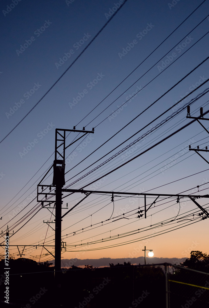 Fototapeta premium power lines and train at sunset