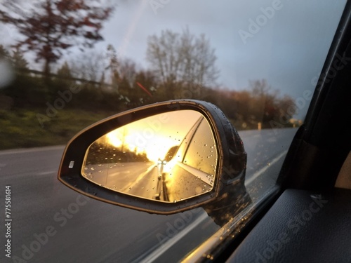 car mirror driving on a road