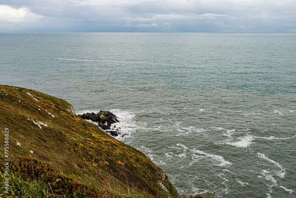 Howth Cliffs, Dublin, Ireland. Cloudy landscape with Ireland coastline and North Sea. Howth Cliffs Walk. Howth Cliffs, Dublin, Ireland. Cloudy landscape with Ireland coastline and North Sea. Howth Cliffs Walk.