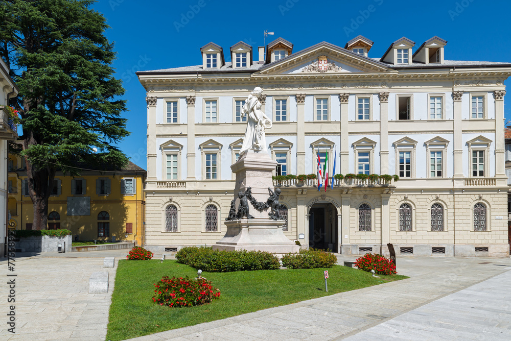 Beautiful square in an old city in Europe. Domodossola, ancient city in northern Italy, historic center with the City Palace, as written above the entrance, (year 1847), seat of the town hall - obrazy, fototapety, plakaty 