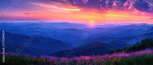 A beautiful sunset over a mountain range with a purple sky © Woraphon