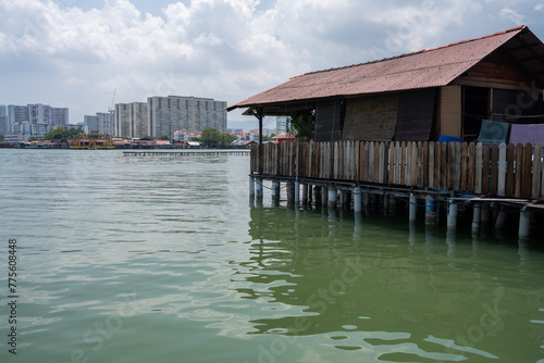Chew Jetty on Penang in Malaysia is a place with wooden houses on wild constructions and piers in the water © Willi