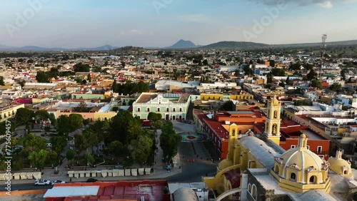 Aerial view backwards over the Parque Juárez and the San Luis Obispo Baroque, sunset in Huamantla, Mexico photo