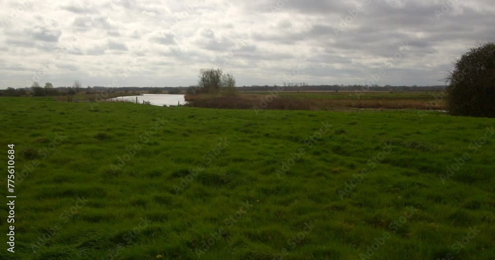 Wide shot a meadow at St Benet’s abbey with the Bure in background. At Norfolk Broads, Ludham on the river Bure Wide shot a meadow at St Benet’s abbey with the Bure in background. At Norfolk Broads, Ludham on the river Bure