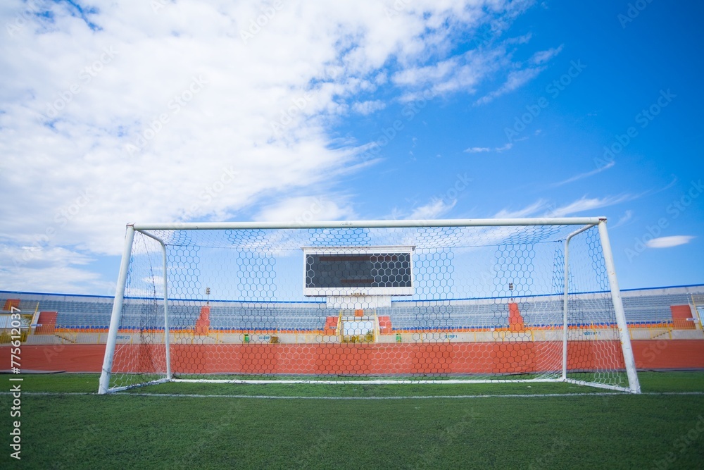 STADIUM - Football field with goal and tablo on blue sky - obrazy, fototapety, plakaty 