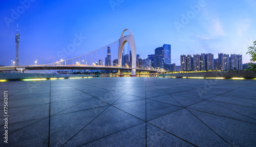 Empty square floor and bridge with modern city buildings scenery at night in Guangzhou
