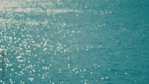 Abstract And Background Concept. Small Waves On Water Surface In Motion Blur With Bokeh Lights.