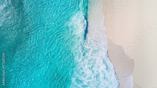 banner with the surface of the sea on one side and a beach with white sand and waves on the other side. top view of a breathtaking natural location for a relaxing holiday