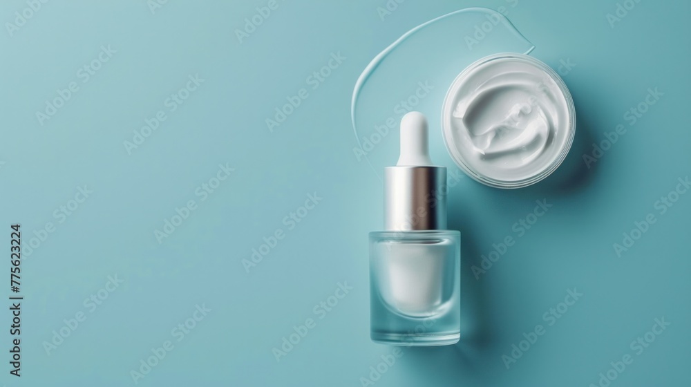 Cream and serum bottles on blue background Cream and serum bottles on blue background