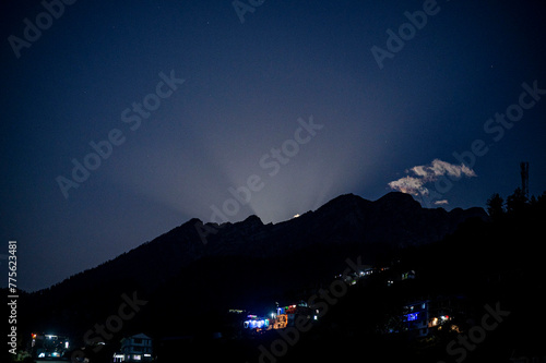 Moon rise behind the mountains photo