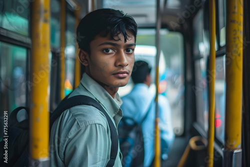 Portrait of an indian school boy standing on a bus