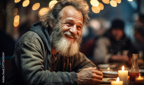 Warmly smiling elderly bearded man in casual clothes enjoying a meal at a busy social gathering with festive lights in the background photo