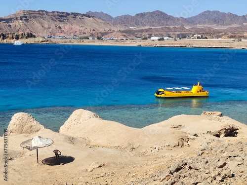 yellow ship. a yellow ship sails on a calm blue sea. yellow on blue background