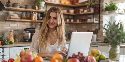 Atkins Ambition: With Determination In Her Eyes, A Young Woman Tackles Her Tasks On Her Laptop, Supported By Low-Carb Fruits In Her Workspace