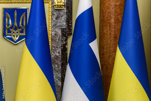 The national flags of Ukraine and Finland on the background of the Trident, the State Emblem of Ukraine