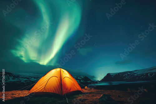 Aurora borealis over a glowing orange tent at night. Northern lights in Iceland. Starry sky with polar lights. Camping and hiking in Iceland. © Ekaterina Pokrovsky