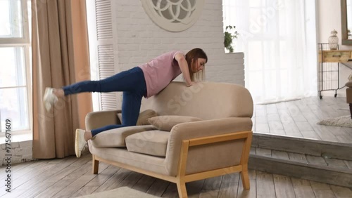 A woman has lost something and is looking for money or keys in the sofa, under the sofa and carpet