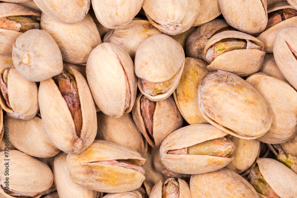 Background of the roasted salted pistachio nuts close-up Background of the roasted salted pistachio nuts close-up
