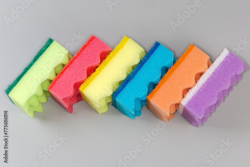 Multi colored synthetic cleaning sponges with hard urethane abrasive layer
