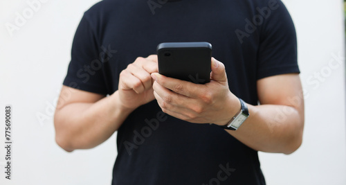 close up young man hand hold smartphone and heck about social media news feed or reading article on website and online shopping for people lifestyle and technology concept