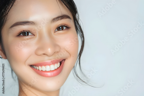 Closeup portrait of Beautiful smiling Asian woman with smooth healthy skin