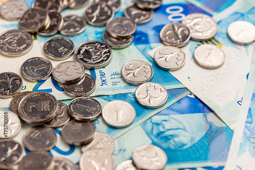 Tablou pe pânză New Israeli shekel coins and bills lie on the table. Shekels.