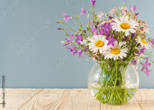 Wallpaper Mural Bouquet of wildflowers in a round glass vase on a blue background

 Torontodigital.ca