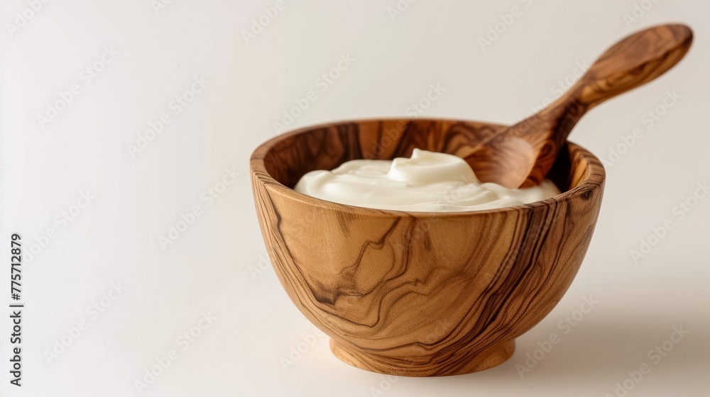 Tasty yoghurt in a wooden bowl isolated on a white background. Tasty yoghurt in a wooden bowl isolated on a white background.