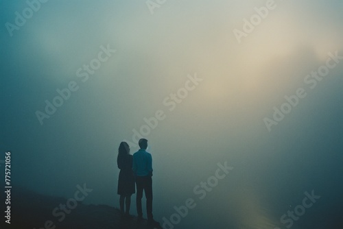 Couple standing by each other in the fog, romantic dark natural scene