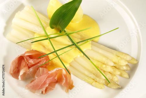White Asparagus with Sauce Hollandaise, smoked Ham and Potatoes on white Background - Plate