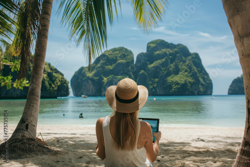 Traveler woman relaxing on cradle using tablet with beautiful view on the beach.