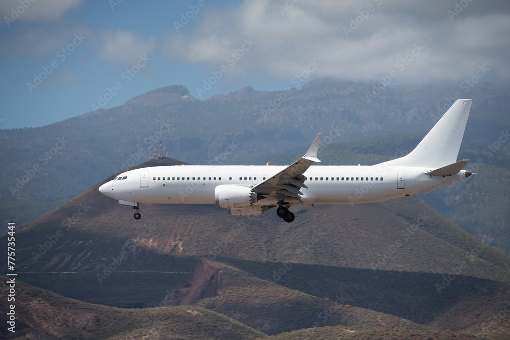 Obraz premium The plane lands.Airplane, passengers flying in the blue sky, preparing to land at the airport