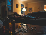 A subdued living room ambiance featuring an overuse of medication and wine, hinting at issues of dependency.
