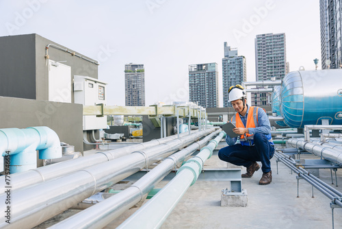 Obraz na plátně engineer male technician worker working service hotel boiler tank hot water supply pipe system