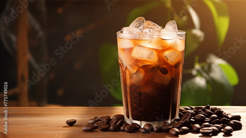 A tall glass of creamy iced coffee, swirled to perfection, stands amidst scattered coffee beans on a warm wooden table, illuminated by ambient café lighting.