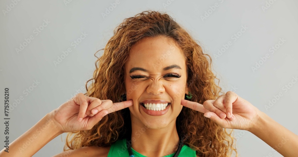 Woman, funny face and studio with goofy comedy on grey background or ...