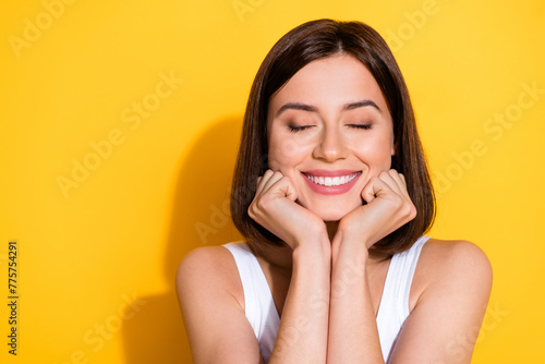 Photo portrait of attractive young girl dreamy closed eyes wear trendy white outfit isolated on yellow color background
