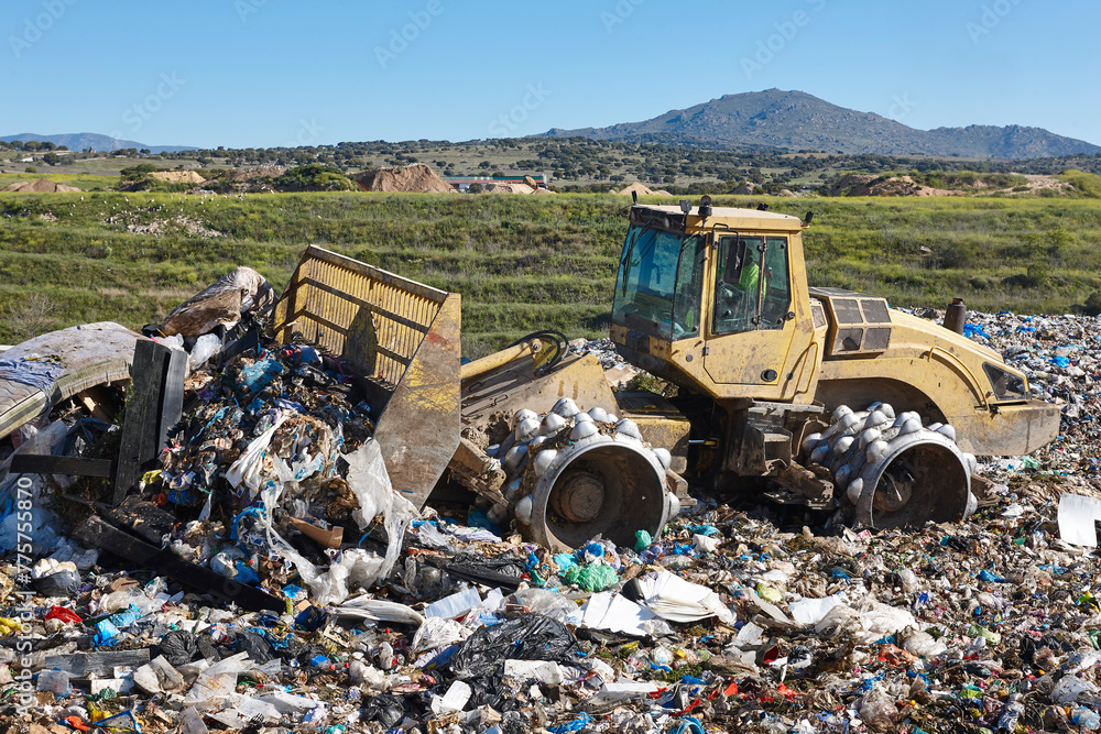 Heavy machinery shredding garbage in an open air landfill. Pollution Heavy machinery shredding garbage in an open air landfill. Pollution