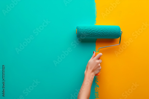 Hand with paint roller on wall, contrasting colors, home improvement concept. Copy space. photo