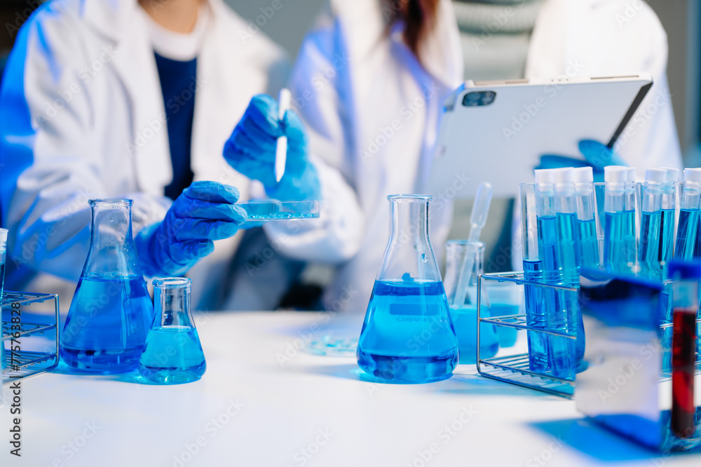 Fototapeta premium Scientist team meeting and writing analysis results in the laboratory study and analyze scientific