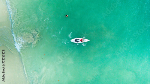 Top view of kayak boat oin shallow turquoise water of Kapas Island sea, Kuala Terengganu, Malaysia. © doublealpha